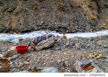 Washing Clothes by a Rocky River in Kyrgyzstan Washing Clothes by a Rocky River in Kyrgyzstan 140809685