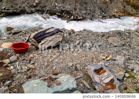 Outdoor Laundry Preparation by Fast-Flowing Mountain River Outdoor Laundry Preparation by Fast-Flowing Mountain River 140809686