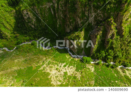 Aerial View of a River Winding Through a Green Gorge Aerial View of a River Winding Through a Green Gorge 140809690
