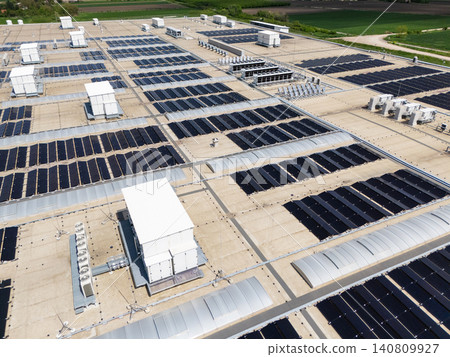 Aerial view of a modern factory with solar panels and energy storages on the roof. Aerial view of a modern factory with solar panels and energy storages on the roof. 140809927
