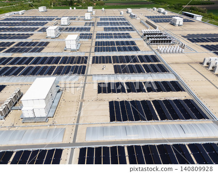 Aerial view of a modern factory with solar panels and energy storages on the roof. Aerial view of a modern factory with solar panels and energy storages on the roof. 140809928