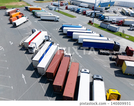 Aerial view of a logistics hub with multicolored shipping containers and trucks Aerial view of a logistics hub with multicolored shipping containers and trucks 140809931