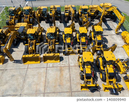 New hydraulic excavators and tractors parked at a construction machinery dealership New hydraulic excavators and tractors parked at a construction machinery dealership 140809940