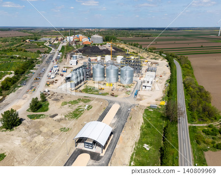 Construction site of a modern agricultural complex with silos, grain elevator and storage terminal. Aerial view. Construction site of a modern agricultural complex with silos, grain elevator and storage terminal. Aerial view. 140809969