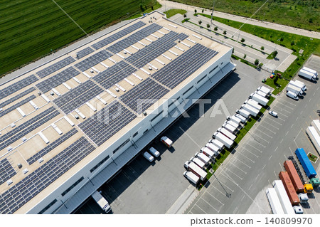 Aerial view of a modern logistics center with solar panels on the roof. Aerial view of a modern logistics center with solar panels on the roof. 140809970