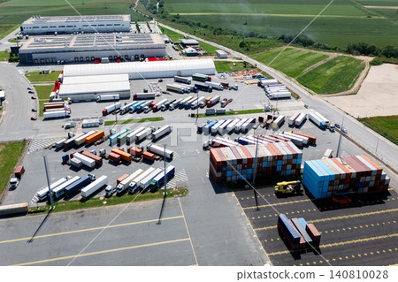 Aerial top view of a green logistics hub with solar panels and shipping containers Aerial top view of a green logistics hub with solar panels and shipping containers 140810028