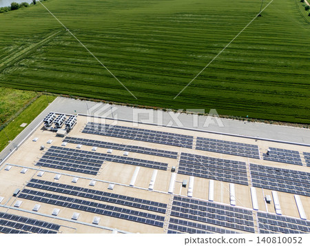 Aerial view of a modern logistics center with solar panels on the roof. 140810052