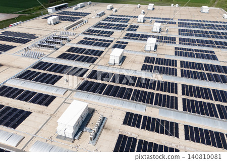 Aerial view of a modern factory with solar panels and energy storages on the roof. 140810081