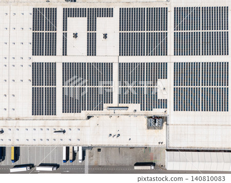Aerial view of a modern logistics center with solar panels on the roof. 140810083