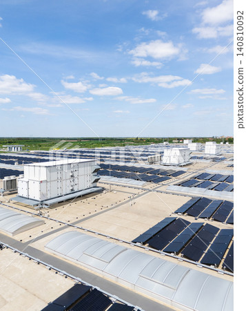 Aerial view of a modern factory with solar panels and energy storages on the roof. 140810092