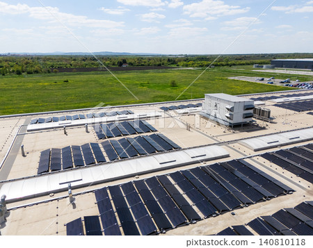 Aerial view of a modern factory with solar panels and energy storages on the roof. Aerial view of a modern factory with solar panels and energy storages on the roof. 140810118
