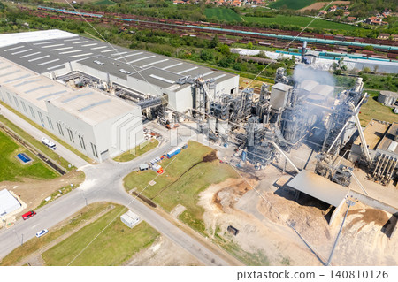 Aerial shot of a manufacturing facility with smoking chimney during production. 140810126
