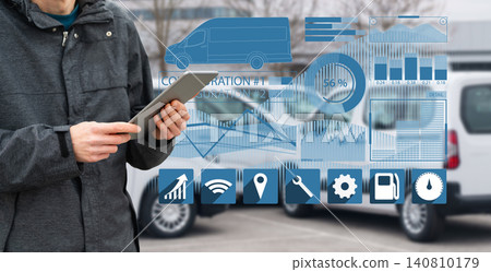 Fleet manager with digital tablet supervising rows of white delivery vans.. Fleet manager with digital tablet supervising rows of white delivery vans.. 140810179