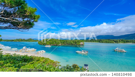 The breathtaking view of Kabira Bay in Ishigaki Island, Okinawa, with glass-bottom boats floating on the water. The breathtaking view of Kabira Bay in Ishigaki Island, Okinawa, with glass-bottom boats floating on the water. 140810498
