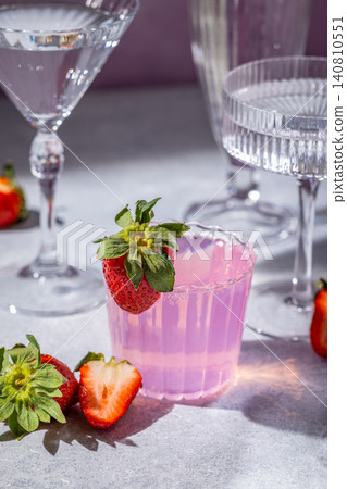 Refreshing pink strawberry cocktail with elegant glassware Refreshing pink strawberry cocktail with elegant glassware 140810551