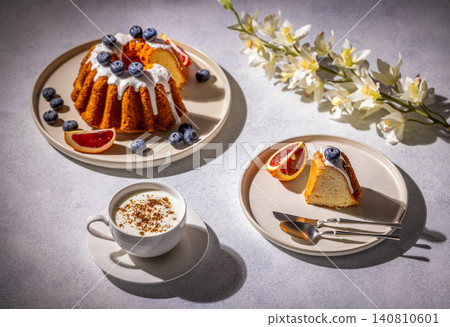 Delicious gugelhupf cake with cappuccino and orchid decoration Delicious gugelhupf cake with cappuccino and orchid decoration 140810601