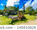 Okinawa Prefecture, Yubu Island: A water buffalo cart sculpture and lush green park scenery. 140810826