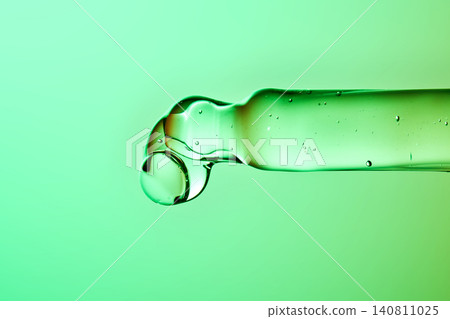 Dripping hyaluronic serum showing skincare hydration technology 140811025