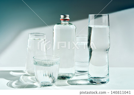 Water bottles and glasses showcasing purity and hydration Water bottles and glasses showcasing purity and hydration 140811041