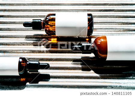 Skincare dropper bottles on industrial corrugated metal background Skincare dropper bottles on industrial corrugated metal background 140811105