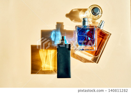 Three perfume bottles casting colorful shadows Three perfume bottles casting colorful shadows 140811282