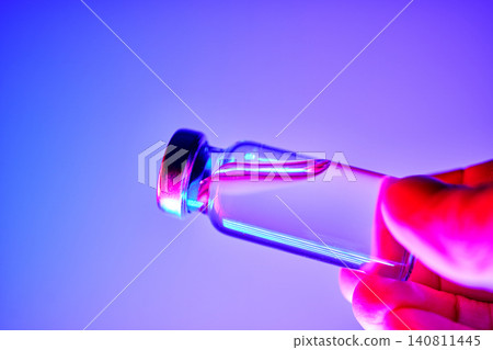 Hand holding glp 1 medication vial for obesity treatment 140811445