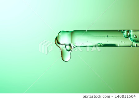 Biotech skincare serum dripping from laboratory pipette Biotech skincare serum dripping from laboratory pipette 140811504