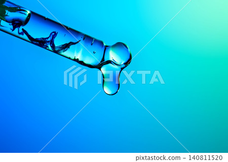 Blue hyaluronic serum dripping from a pipette Blue hyaluronic serum dripping from a pipette 140811520