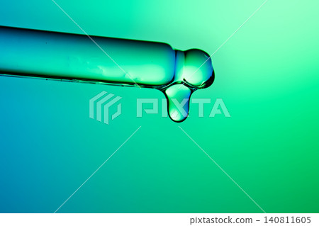 Droplet forming on glass pipette for advanced skincare serum Droplet forming on glass pipette for advanced skincare serum 140811605