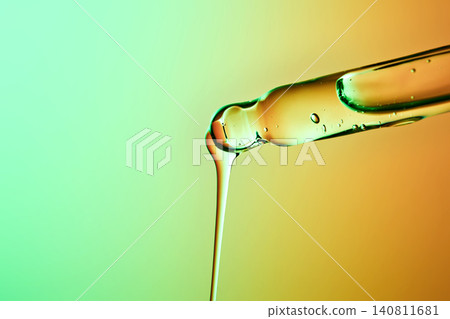 Peptide based serum dripping from a pipette for biotech skincare Peptide based serum dripping from a pipette for biotech skincare 140811681