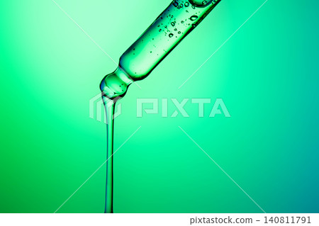 Green liquid dripping from scientific pipette Green liquid dripping from scientific pipette 140811791