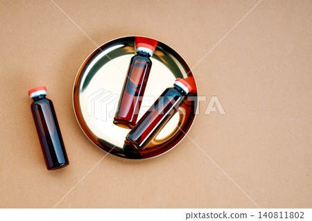 Vials with liquid on golden tray for medical treatment Vials with liquid on golden tray for medical treatment 140811802