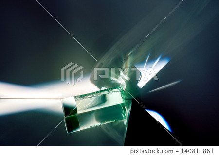 Cosmetic serum vial creating abstract light reflections Cosmetic serum vial creating abstract light reflections 140811861