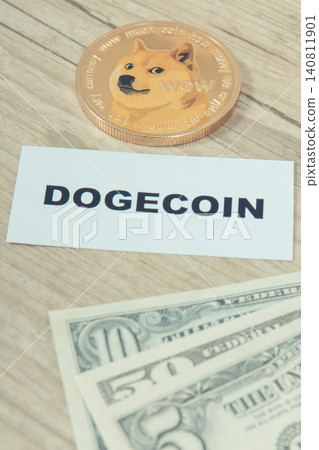 Dogecoin and dollar bills. Cryptocurrency. International network payment. Finance concept Dogecoin and dollar bills. Cryptocurrency. International network payment. Finance concept 140811901