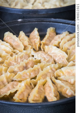 Fried dumplings on frying pan. Traditional food Fried dumplings on frying pan. Traditional food 140811921