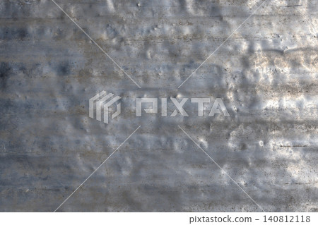 Weathered aluminum surface with dents and scratches outdoors 140812118
