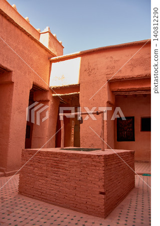 A traditional red brick well stands out in the adobe courtyard of the Taourirt Kasbah in Ouarzazate, Morocco A traditional red brick well stands out in the adobe courtyard of the Taourirt Kasbah in Ouarzazate, Morocco 140812290
