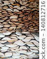 large stack of chopped birch and coniferous firewood stacked vertically 140812716
