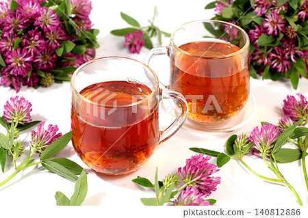 Red clover infusion in glasses with a bouquet of flowers, medicinal herbal tea, alternative folk medicine concept, green pharmacy advertisement, a collection of beneficial herbs for folk medicine, Red clover infusion in glasses with a bouquet of flowers, medicinal herbal tea, alternative folk medicine concept, green pharmacy advertisement, a collection of beneficial herbs for folk medicine, 140812886