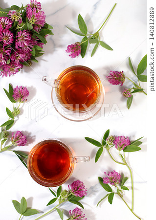 Red clover infusion in glasses with a bouquet of flowers, medicinal herbal tea, alternative folk medicine concept, "green pharmacy" advertisement, a collection of beneficial herbs for folk medicine, Red clover infusion in glasses with a bouquet of flowers, medicinal herbal tea, alternative folk medicine concept, "green pharmacy" advertisement, a collection of beneficial herbs for folk medicine, 140812889