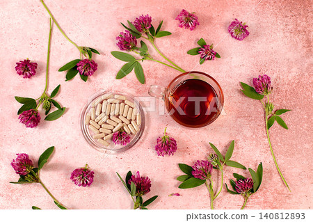 Red clover powder in capsules with a bouquet of flowers, a medicinal herbal composition, an alternative folk medicine concept, an advertisement for a green pharmacy, Red clover powder in capsules with a bouquet of flowers, a medicinal herbal composition, an alternative folk medicine concept, an advertisement for a green pharmacy, 140812893