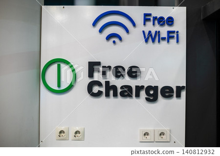 Free wi-fi and charger sign on wall Free wi-fi and charger sign on wall 140812932