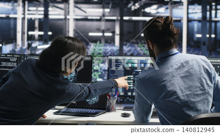 System administrator uses deep learning tools on a digital device in a server room to improve AI operations and system efficiency. System administrator uses deep learning tools on a digital device in a server room to improve AI operations and system efficiency. 140812945