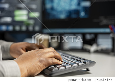 Data center programmer uses a desktop computer in a data center to manage AI systems and optimize server infrastructure. Data center programmer uses a desktop computer in a data center to manage AI systems and optimize server infrastructure. 140813167