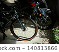 A scene with motorcycles and bicycles 140813866