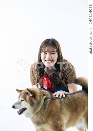 A Shiba Inu and a young woman against a white background. 140814658