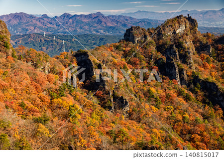 View of the autumn foliage on Ura-Myogi, the rocky peaks of Choto-no-Atama, and the Haruna and Nikko mountain ranges. View of the autumn foliage on Ura-Myogi, the rocky peaks of Choto-no-Atama, and the Haruna and Nikko mountain ranges. 140815017