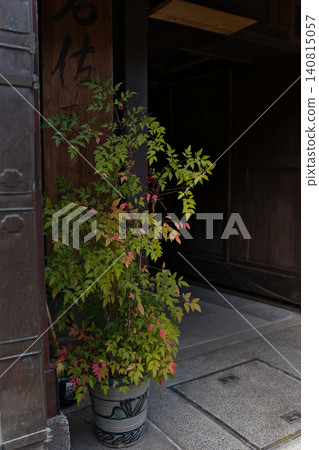 Potted plants adorn the storefronts of traditional townhouses in Hida Takayama. Potted plants adorn the storefronts of traditional townhouses in Hida Takayama. 140815057
