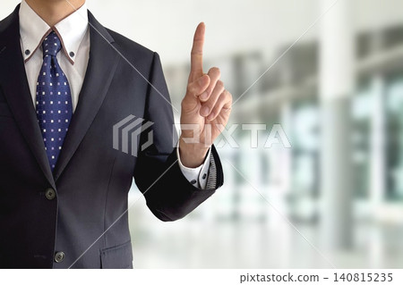A businessman pointing in a key pose. A businessman pointing in a key pose. 140815235