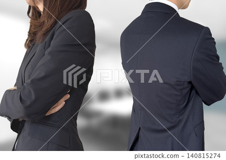Business man and woman in a grim mood with their backs turned Business man and woman in a grim mood with their backs turned 140815274